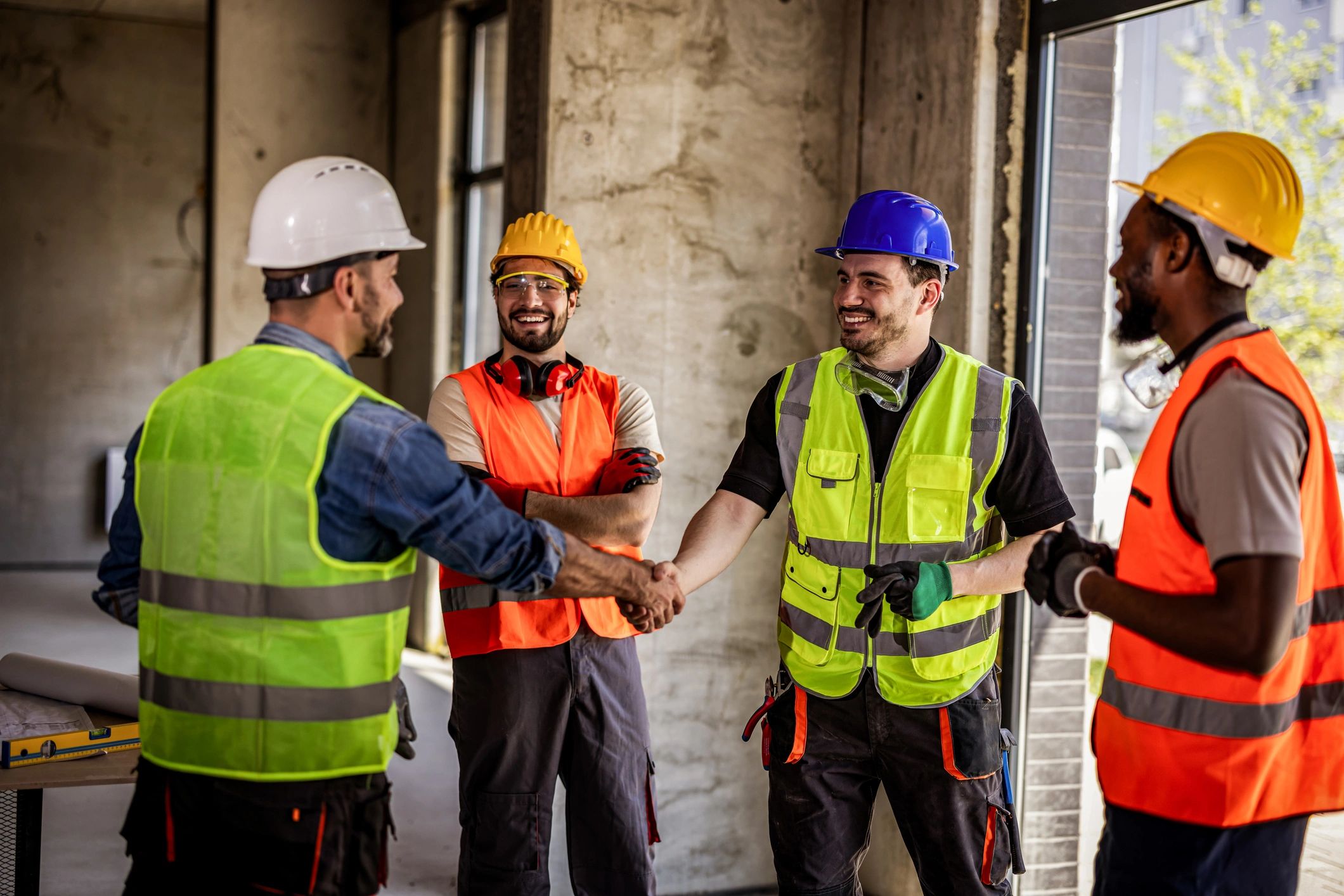 Construction crew members shaking hands on site